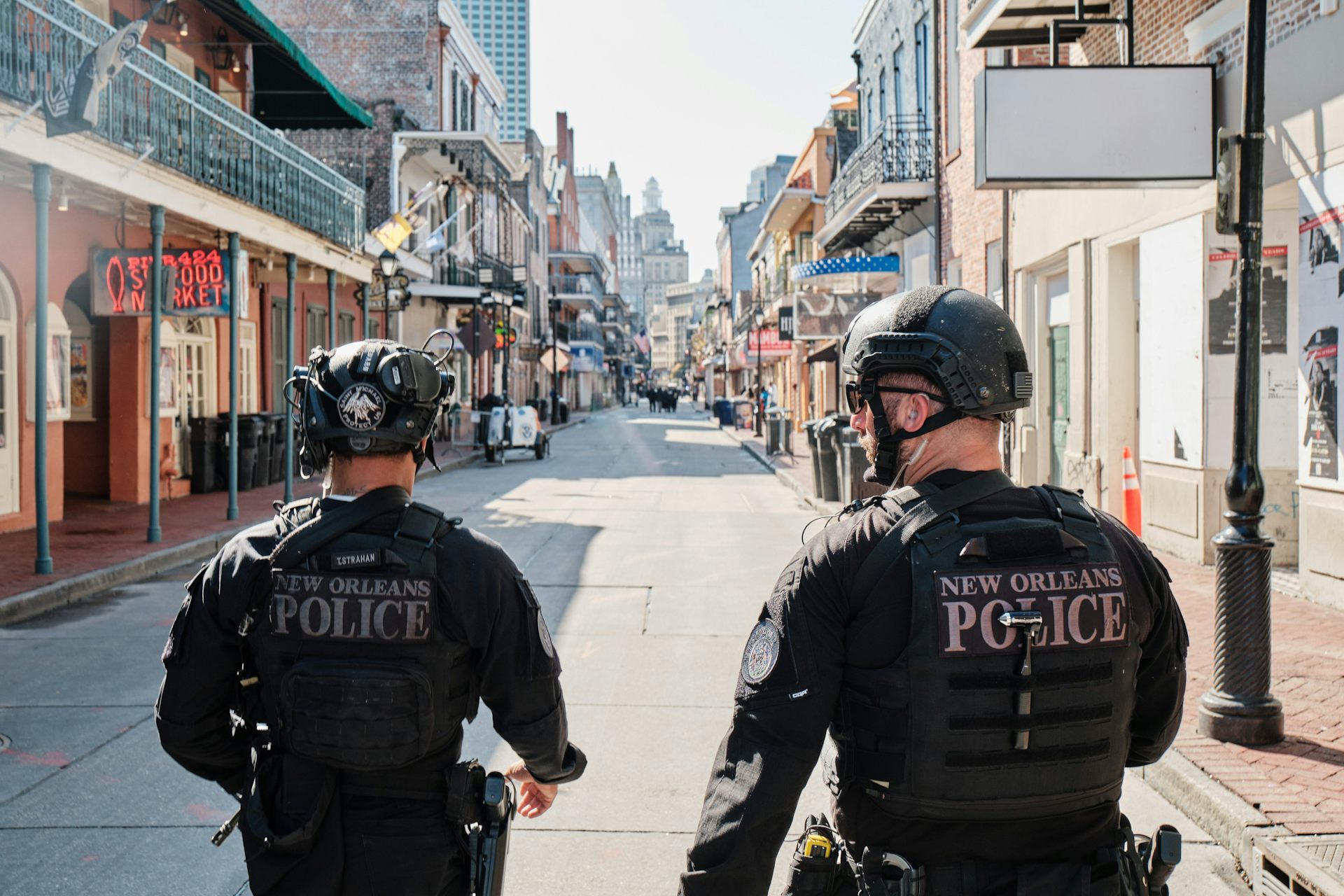 Two policemen walking down Bourbon Street in New Orleans.