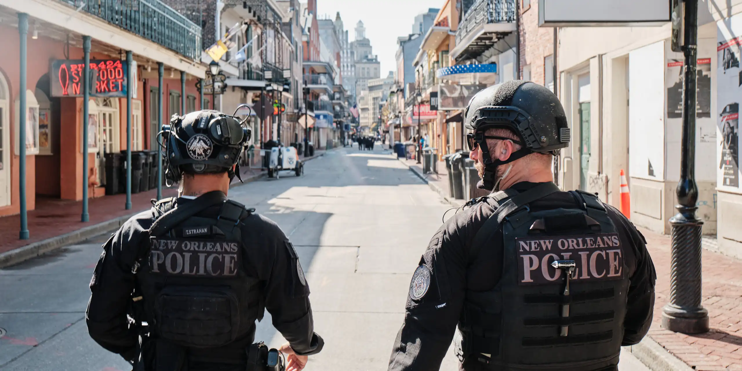 Two policemen walking down Bourbon Street in New Orleans.