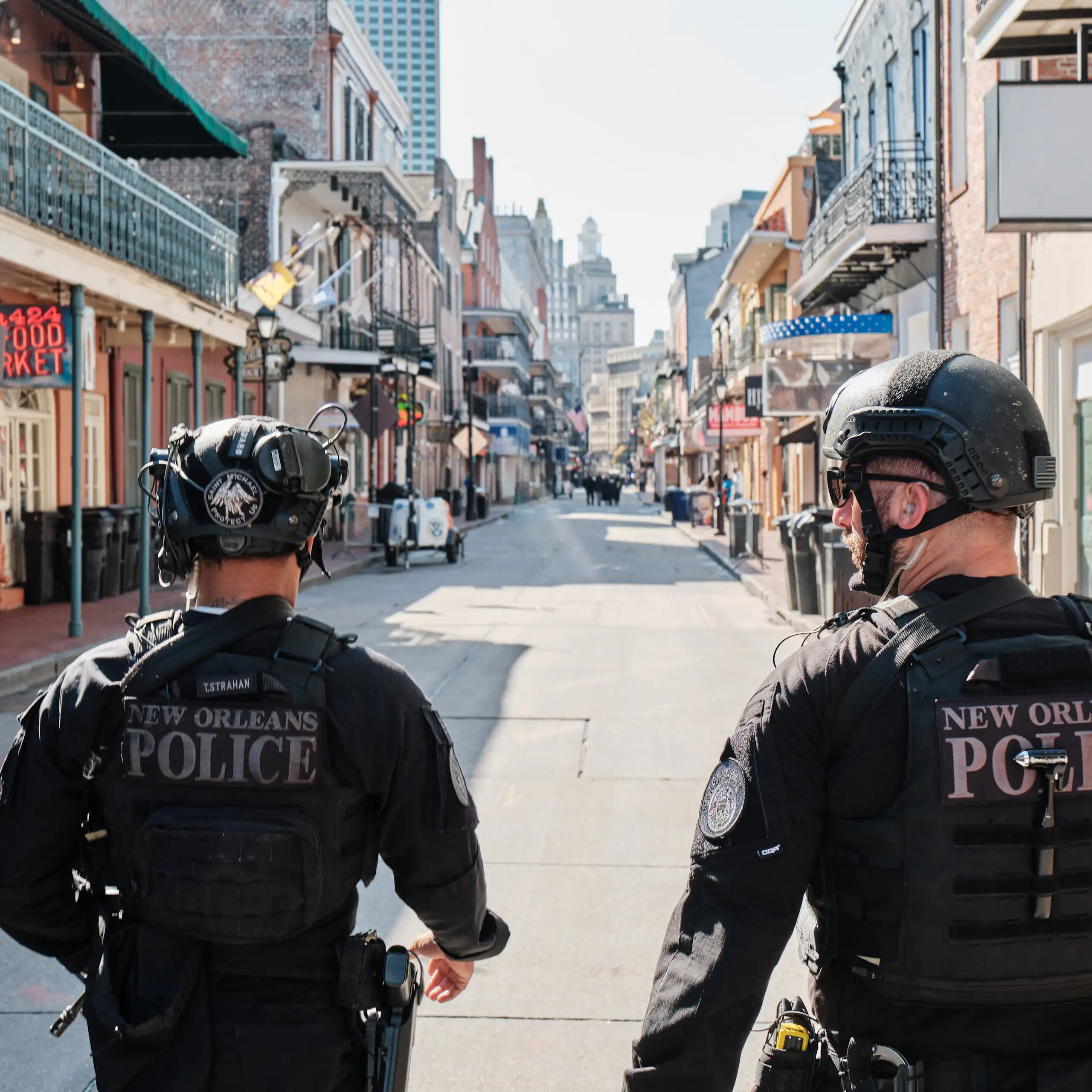 Two policemen walking down Bourbon Street in New Orleans.