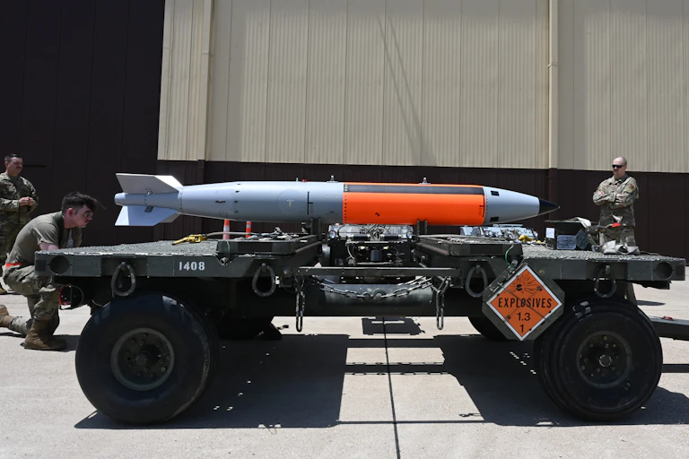A long silver bomb on a truck bed
