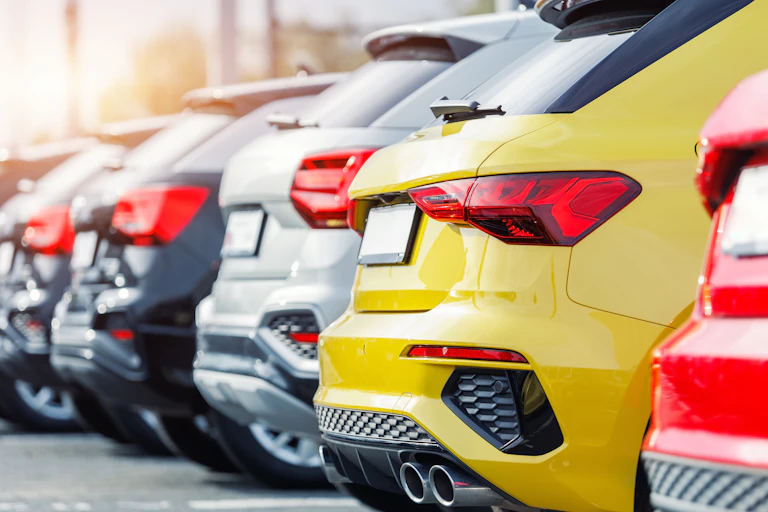 new cars lined up at a dealership