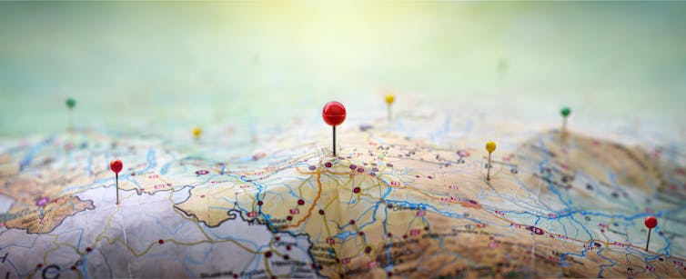 close up of paper map with pins