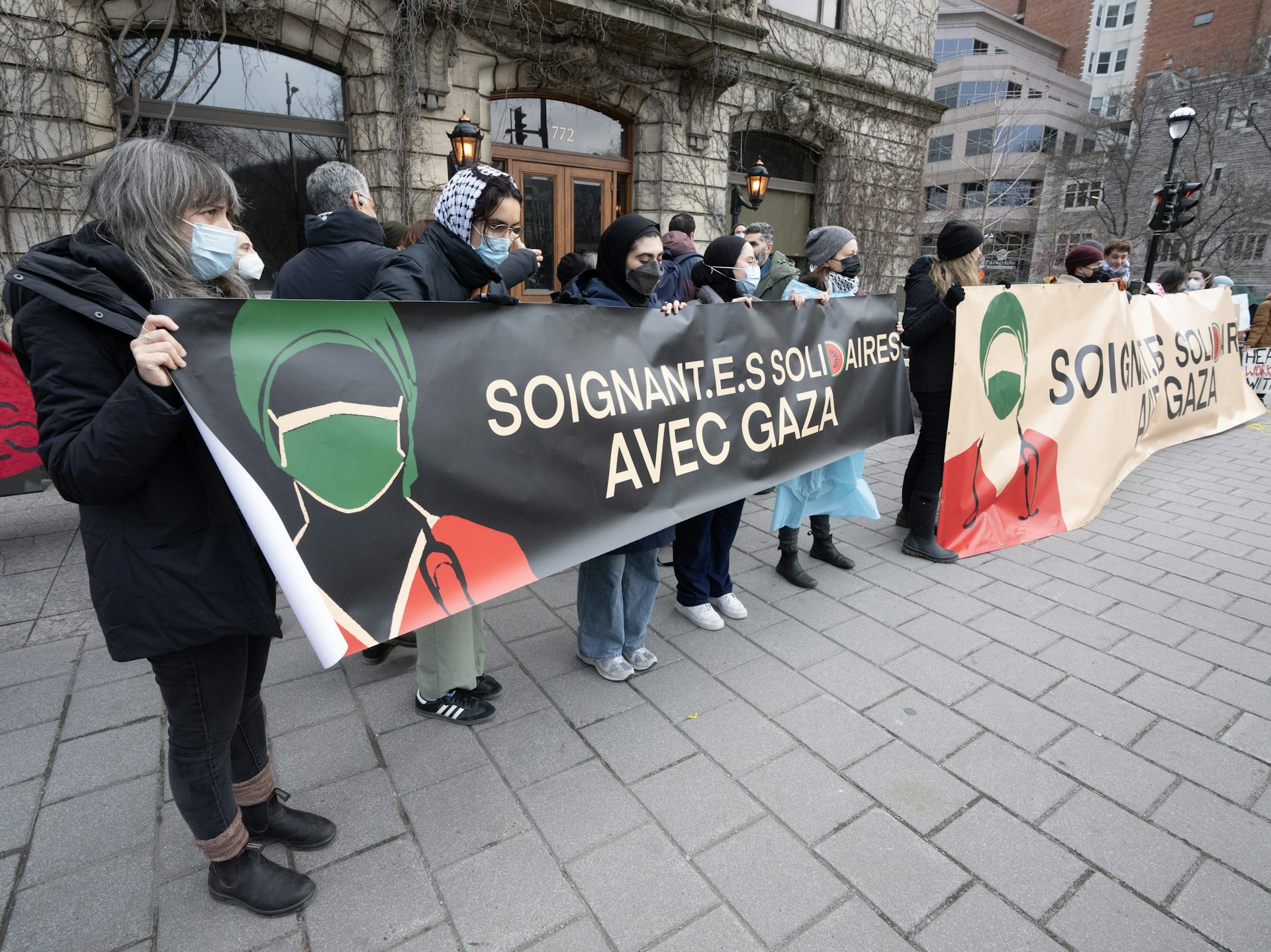 People at a demonstration carry a banner