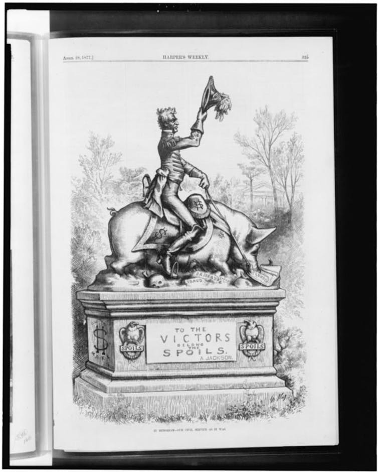 A black and white cartoon from 1877 showing a statue sitting on a hog atop a tomb, engraved with 'To the victors belong the spoils--A. Jackson.'