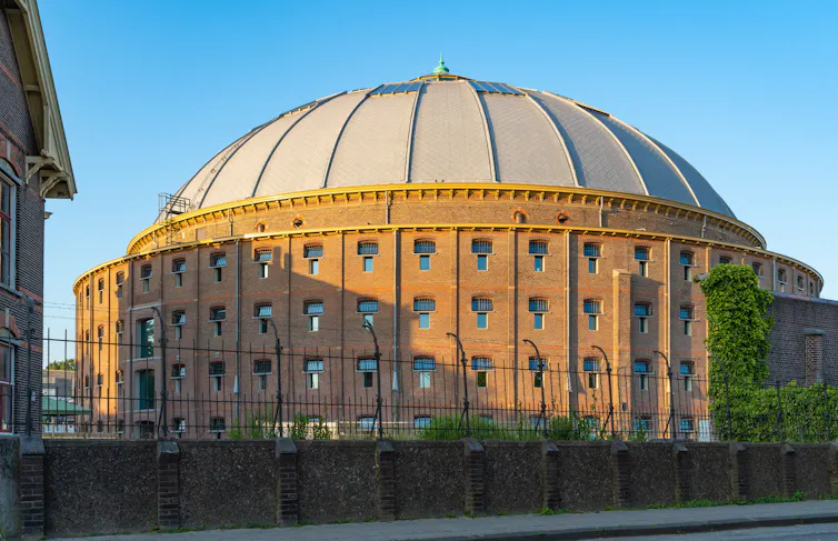 Circular brick building with dome roof.