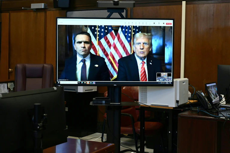 Donald Trump, and his attorney Todd Blanche appear on a screen remotely for a sentencing hearing.