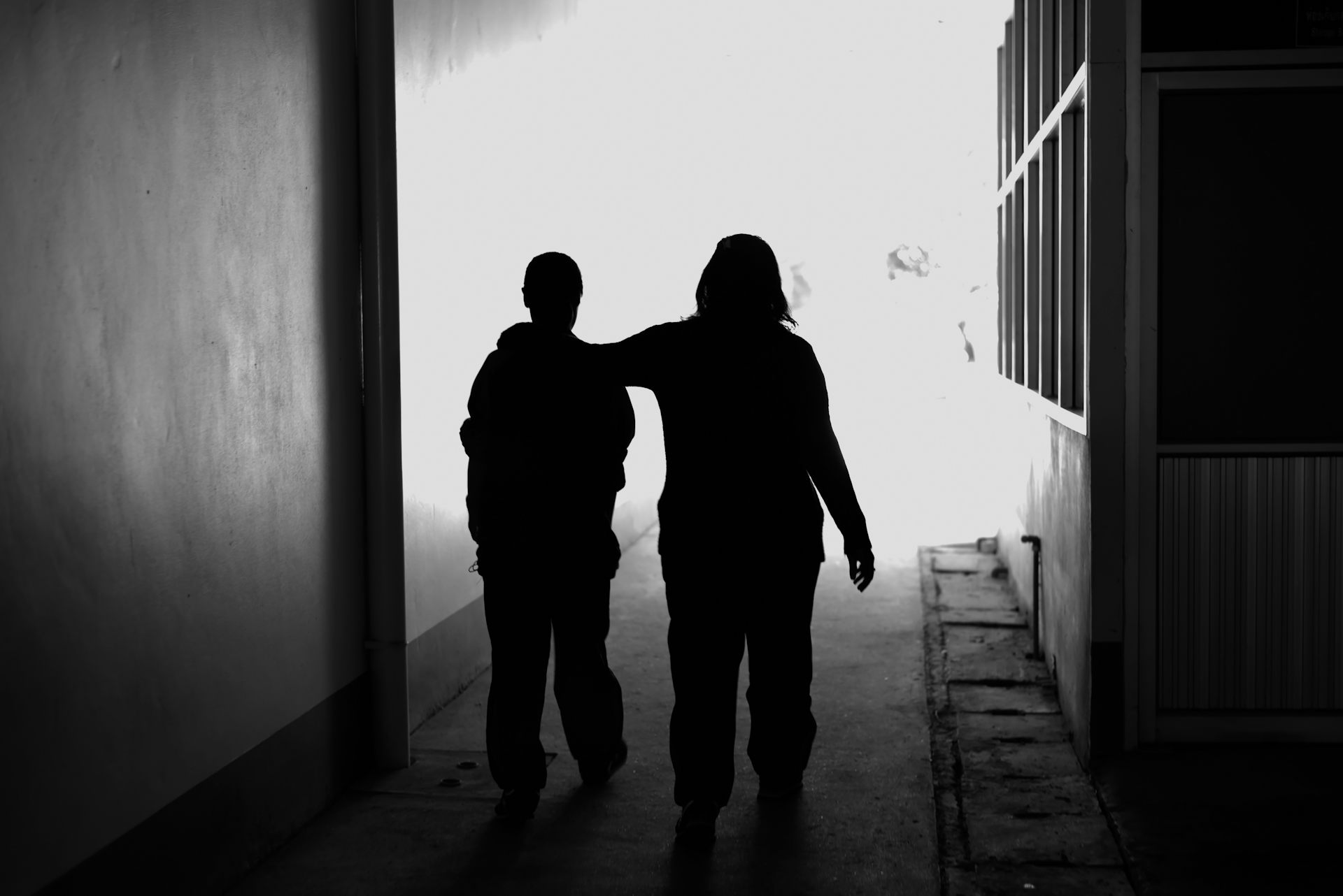 Two women walking silhouetted