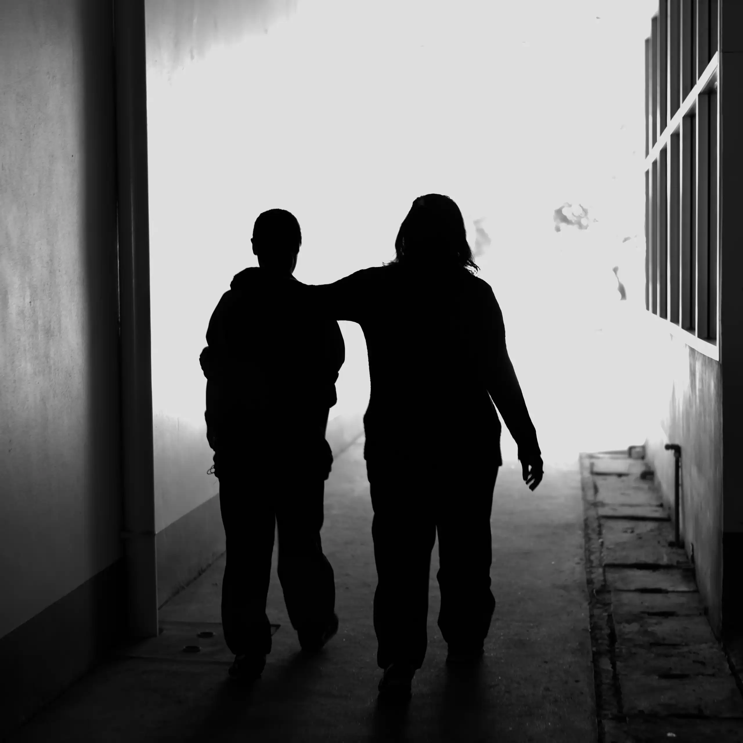 Two women walking silhouetted