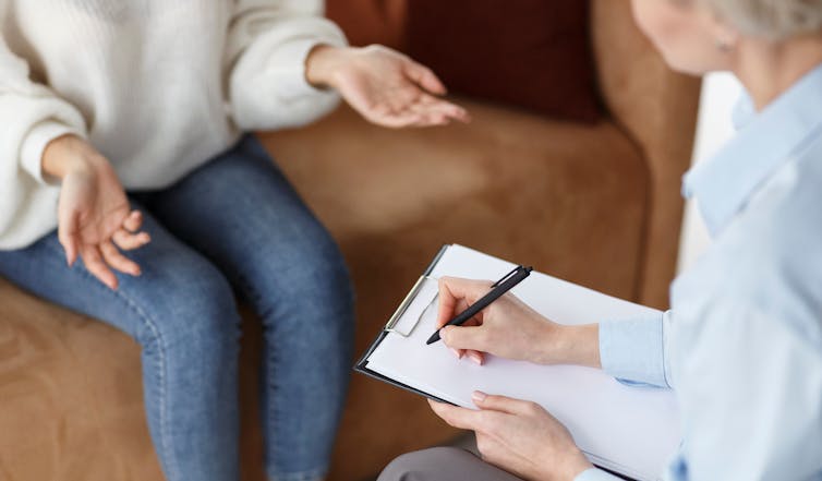Woman talking while another takes notes