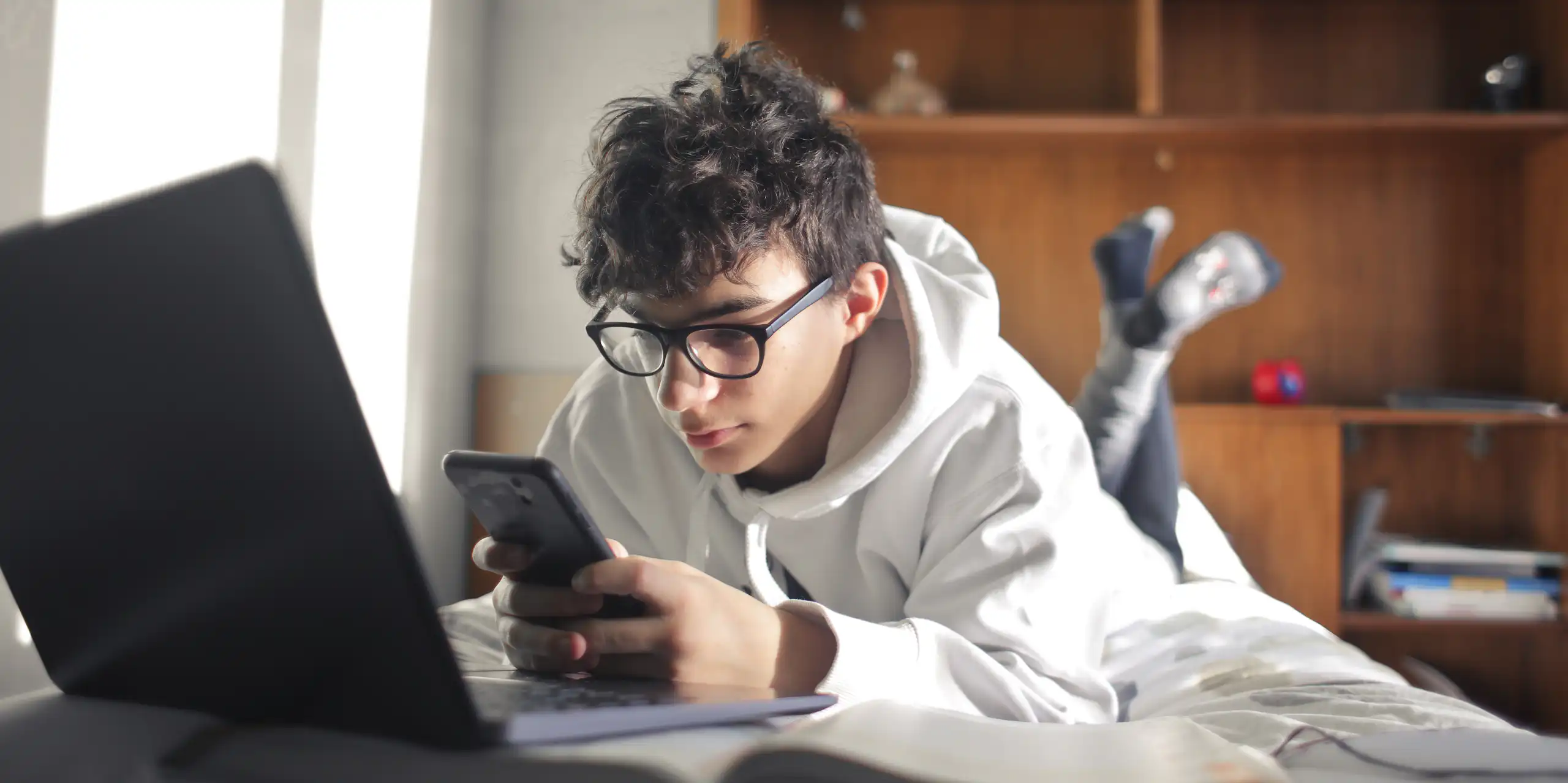 Teenaged boy looks at phone