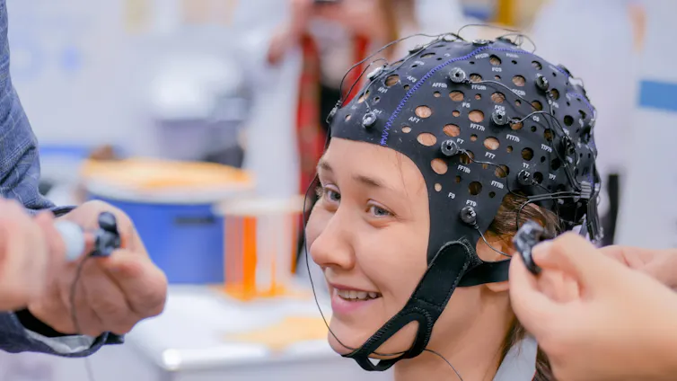 A young girl wearing an EEG headset.