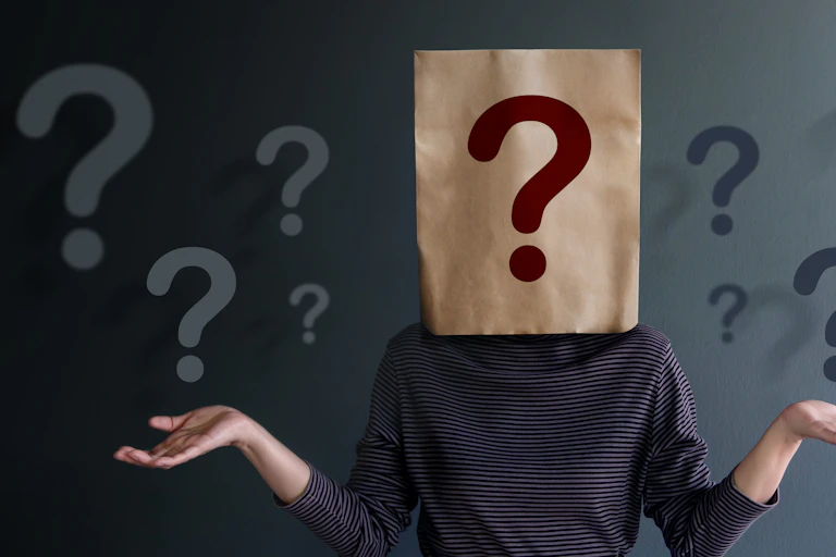 A paper bag with a question mark over a person's body.
