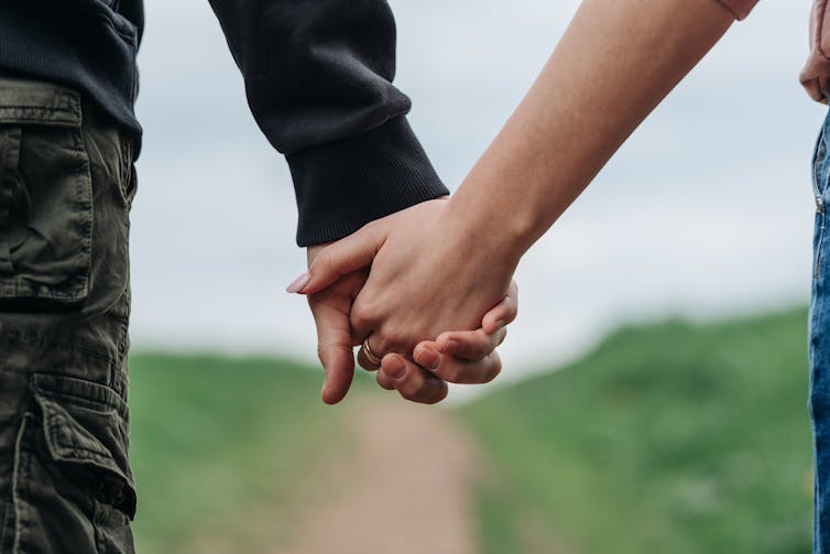 Close up of a man and woman holding hands