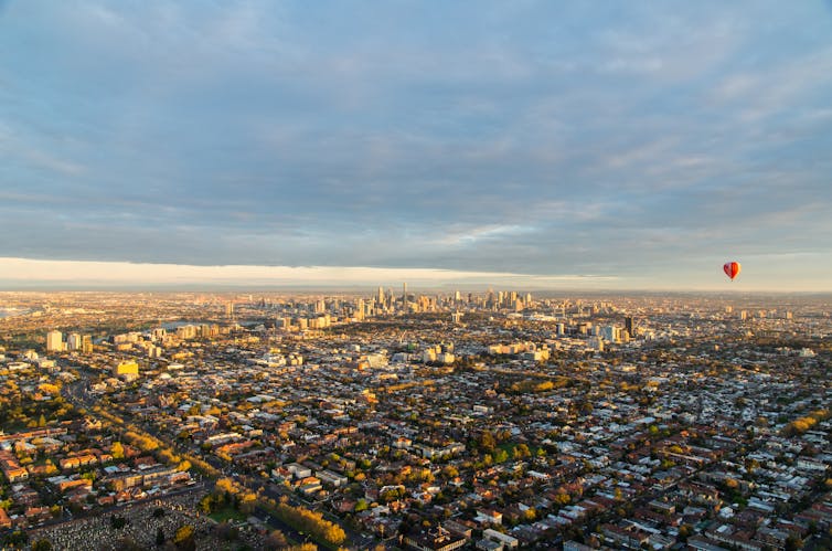 A hot air balloon floating above the urban sprawl of Melbourne, Australia