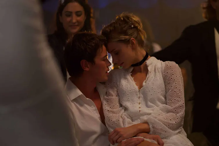 A young man and woman embrace.
