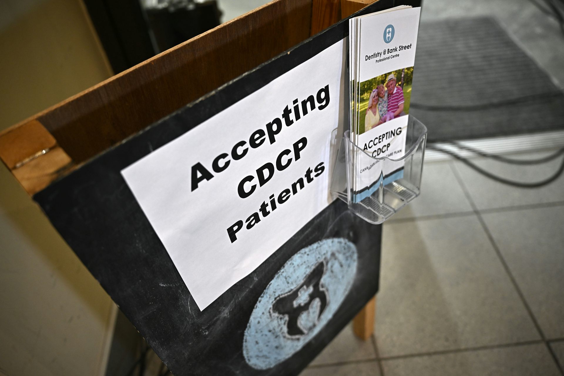 A sign reading 'Accepting CDCP Patients' with a brochures for the program.