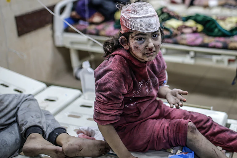 A wounded girl sits on a stretcher at the al-Aqsa Martyrs Hospital in Deir al-Balah, central Gaza Strip