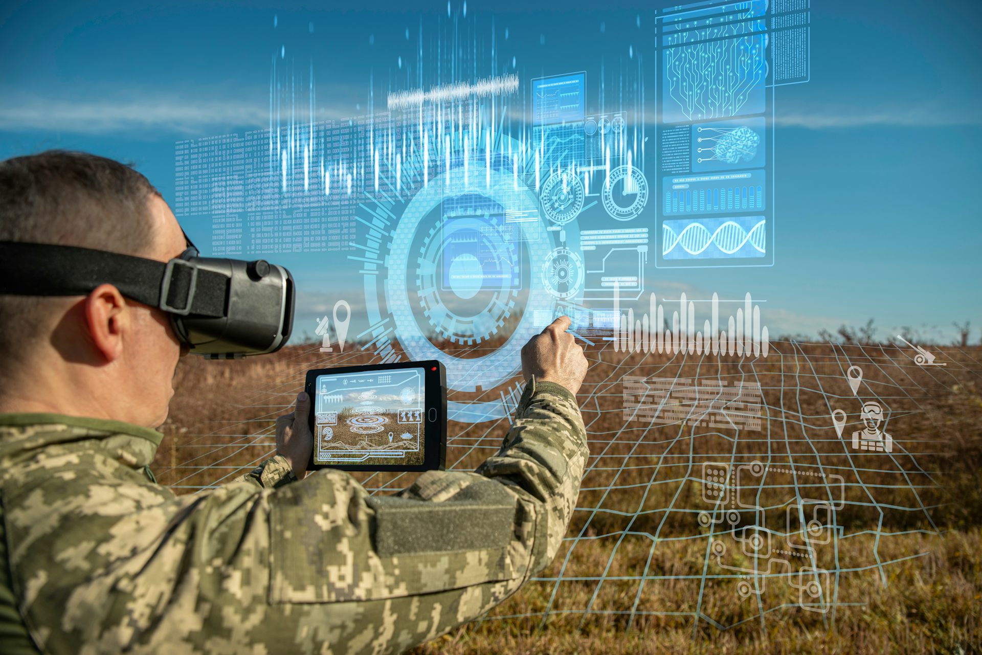 Warfare analytic operator using virtual reality glasses checking coordination of the military team with tablet device augmented device.