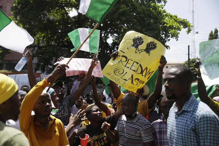 Protestors seen on the street with placards.