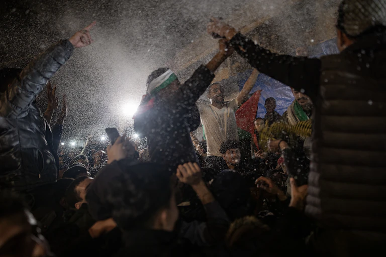 People in in Khan Younis, southern Gaza Strip, react to the news a ceasefire has been agreed.