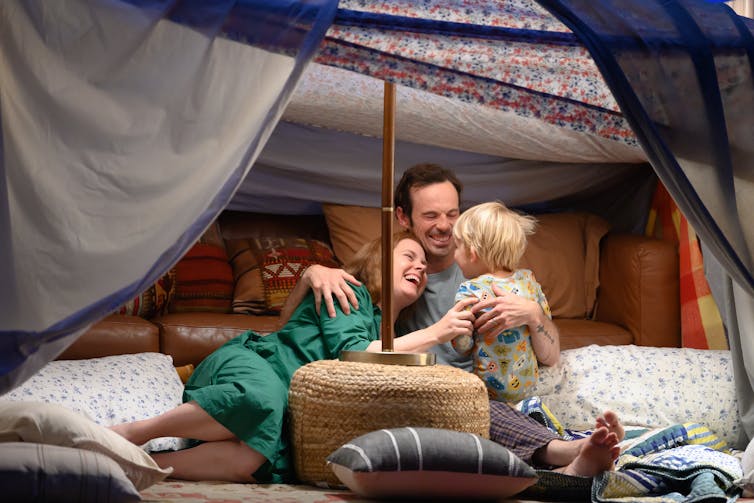 The family being joyous together.