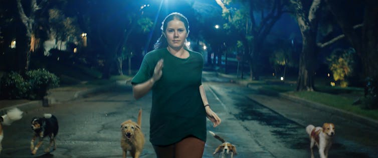 Mother runs with dogs