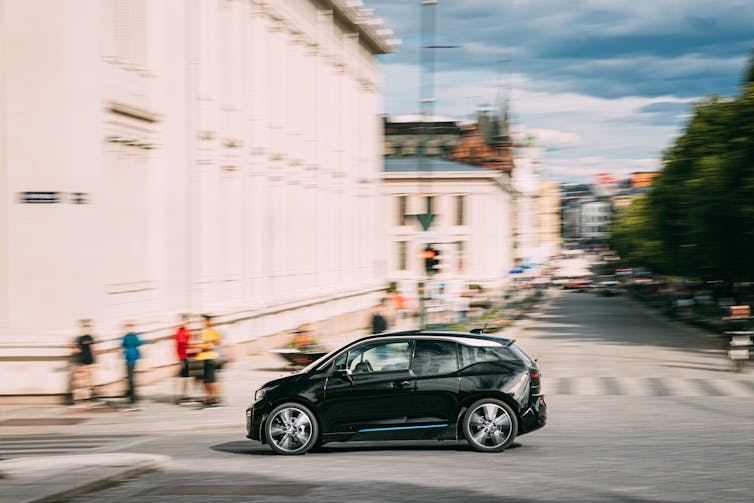 black electric car, blurred, driving along road in Oslo
