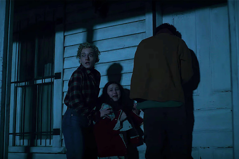 Three people screaming on a porch.