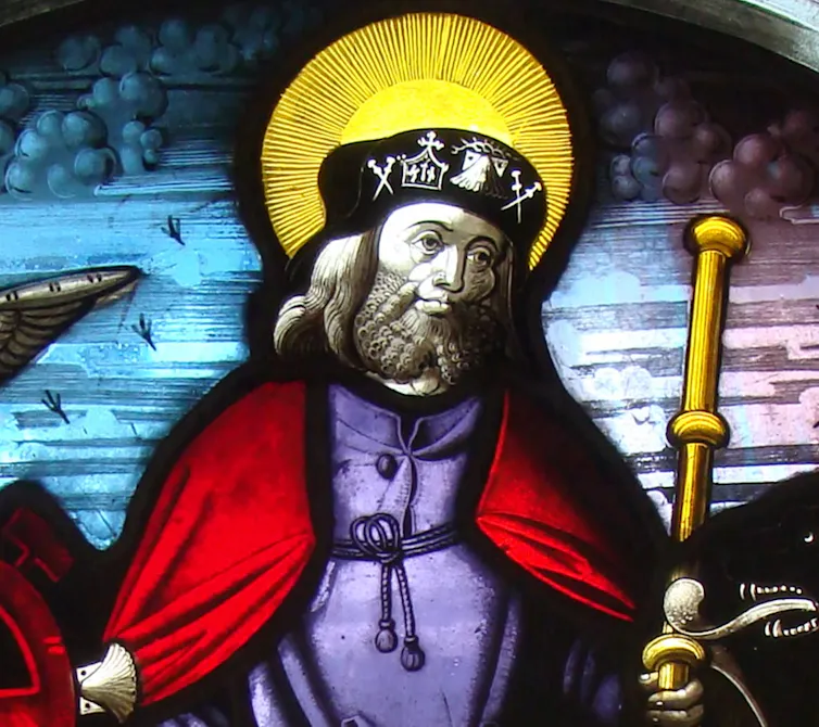A painting of a saint with a halo around his head and a staff in his hand.