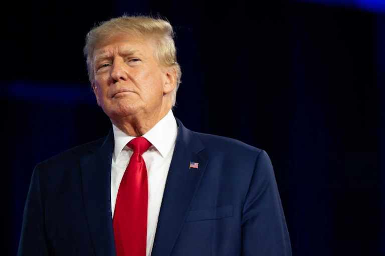 Trump speaking at a conference.