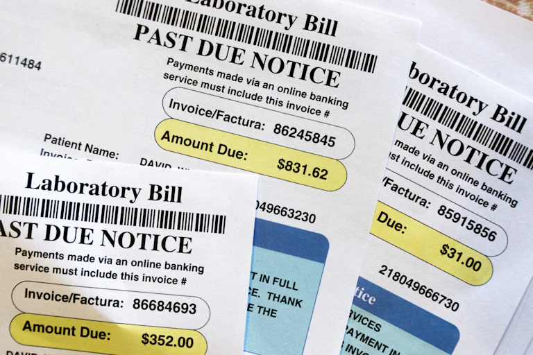 a stack of medical bills that are past due