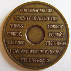 bronze-colored token with serenity prayer engraved on it