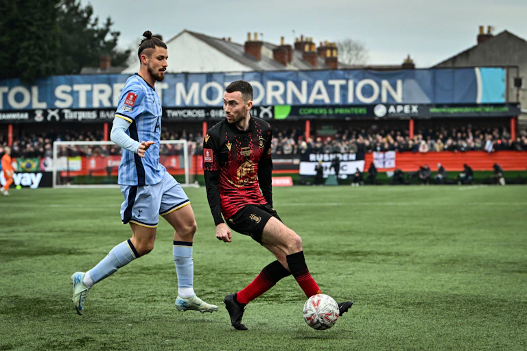 Tamworth footballer Tom McGlinchey, playing football against Tonttenham Hotspurs' Radu Dragusin