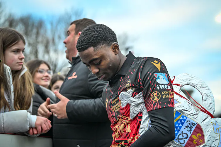Beck-Ray Enoru of Tamworth FC signs autographs