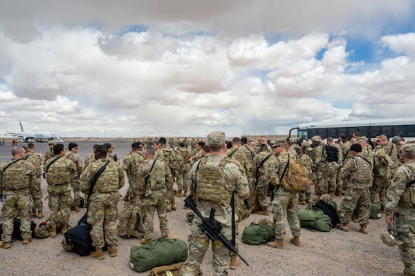 A large crowd of people in military uniforms standing outside.