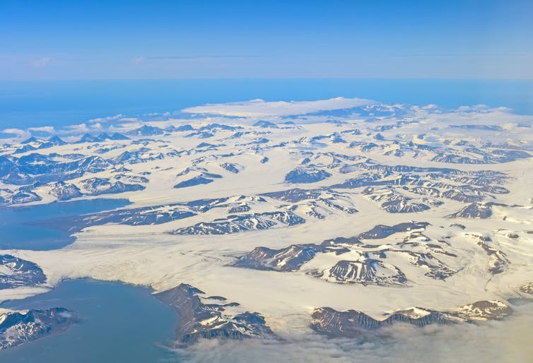 Aerial view of island of mountains and glaciers