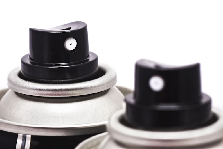 Two black deodorant spray cans.