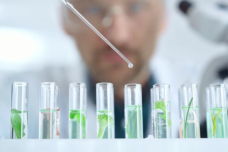 Researcher dripping drops into test tubes.