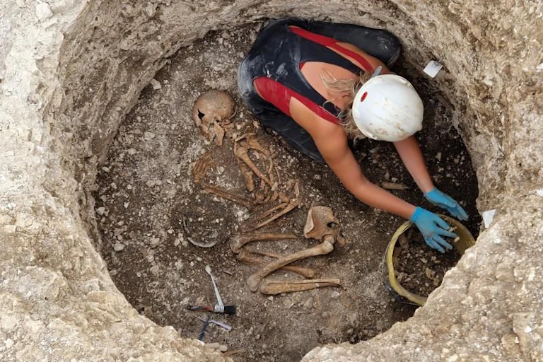 Archaeologist excavating a Late Iron Age Durotriges burial at Winterborne Kingston.