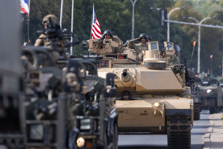 US tanks in a parade with US flag flying