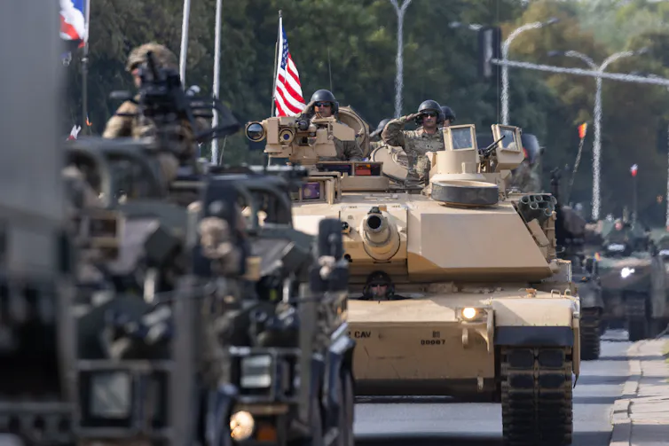 US tanks in a parade with US flag flying