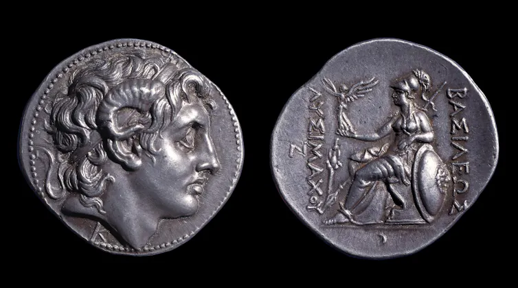 A silver coin, front and back.