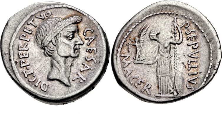 The back and front of a silver coin.