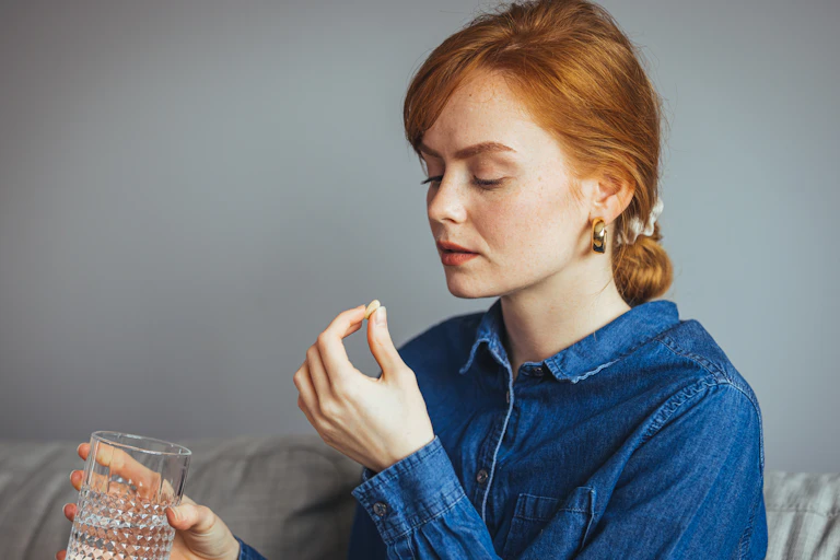 Woman takes tablet
