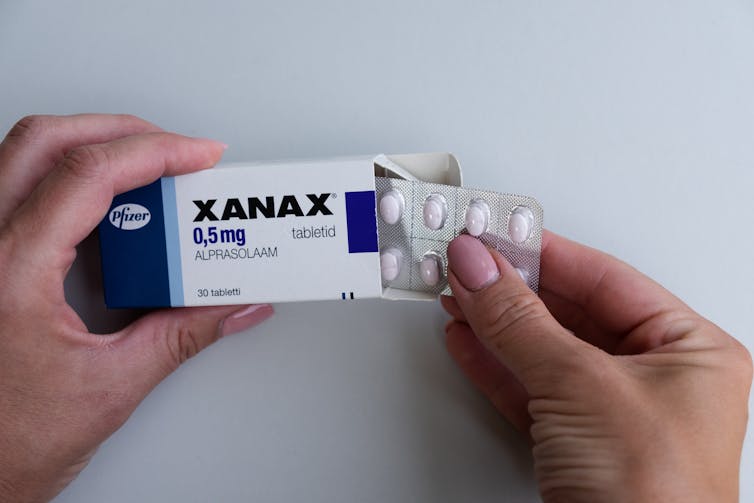 Person takes Xanax out of pack