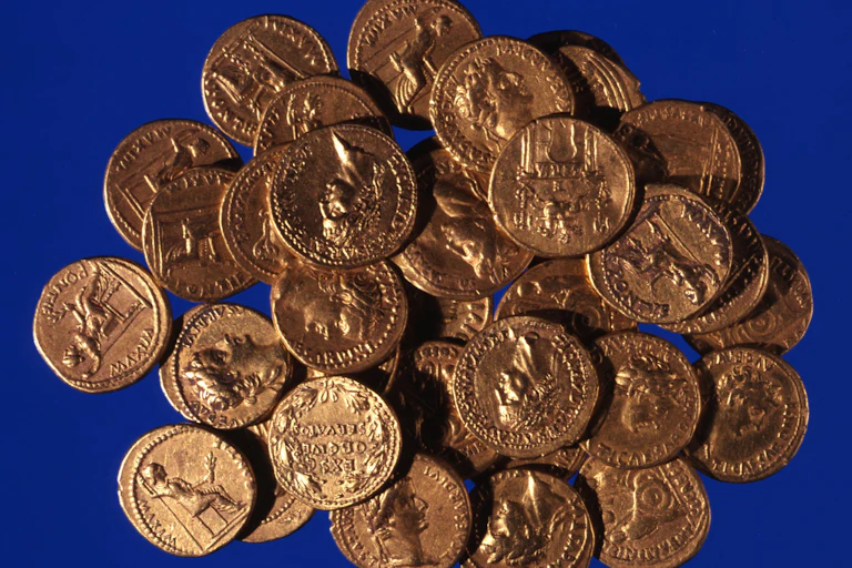 A pile of coins on a blue background.