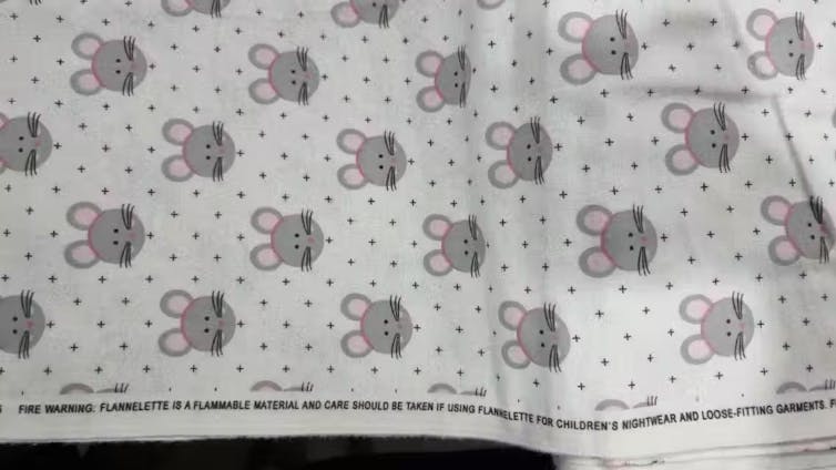 A cute fabric with a mouse and polka dot pattern.