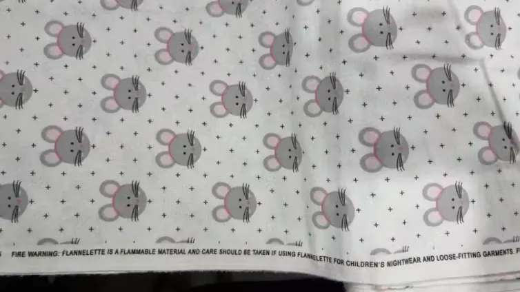 A cute fabric with a mouse and polka dot pattern.