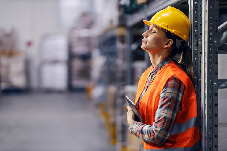 tired woman at work in a warehouse
