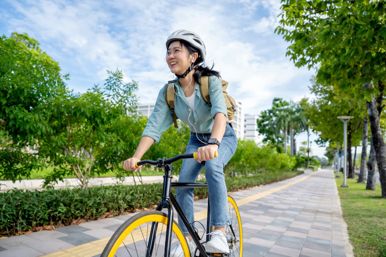 A woman on a bicycle on an urban cycle lane.